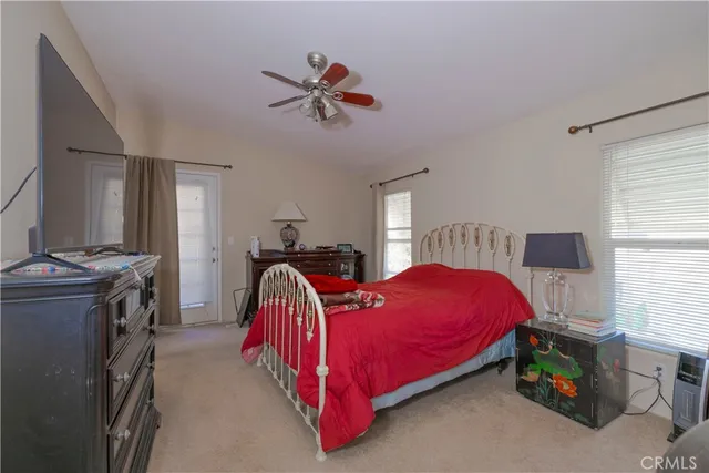 a bed room with a bed and a television