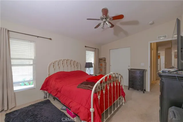 a bathroom with a granite countertop sink toilet and mirror