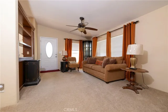 a living room with furniture a fireplace and a large window