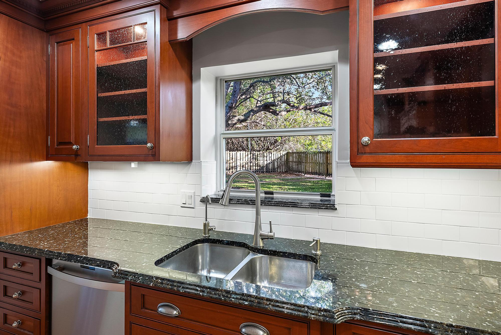 81 Southeast Beech Tree Lane Stuart, FL 34994 - Photo 12 of 27 a kitchen with granite countertop a sink and a window