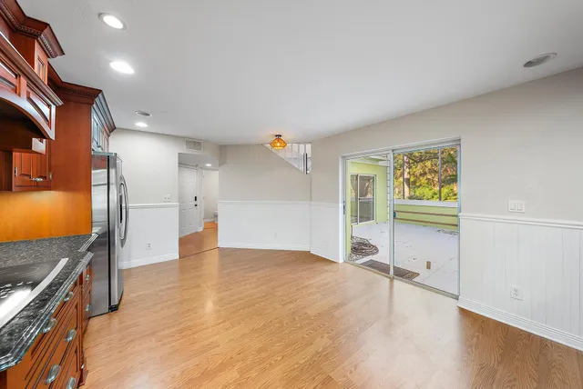 a view of a kitchen with a sink and a refrigerator