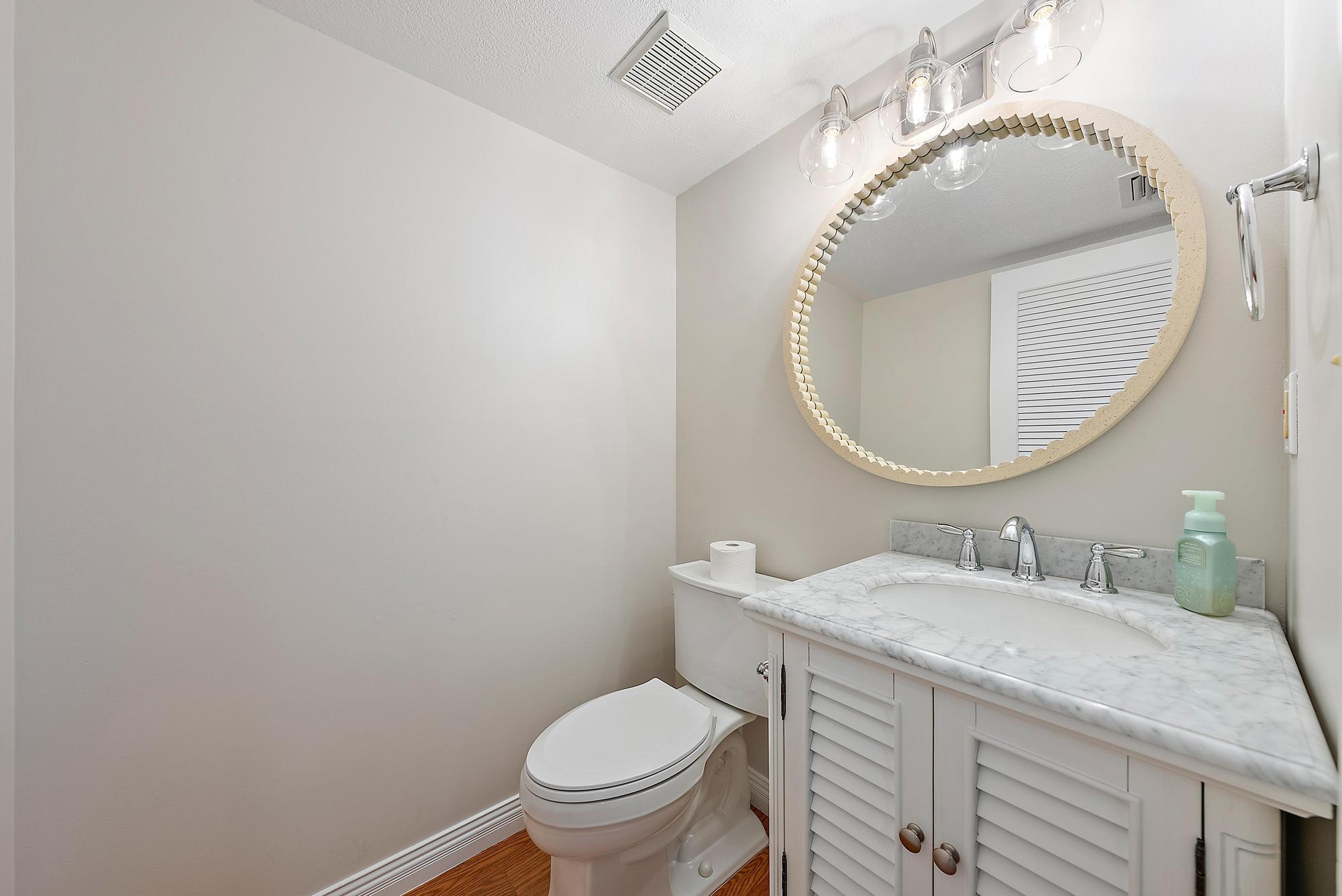 81 Southeast Beech Tree Lane Stuart, FL 34994 - Photo 15 of 27 a bathroom with a sink and a mirror