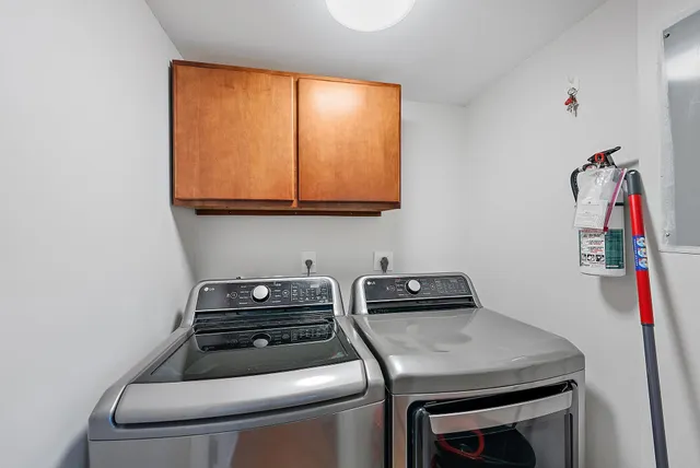 a utility room with sink dryer and washer