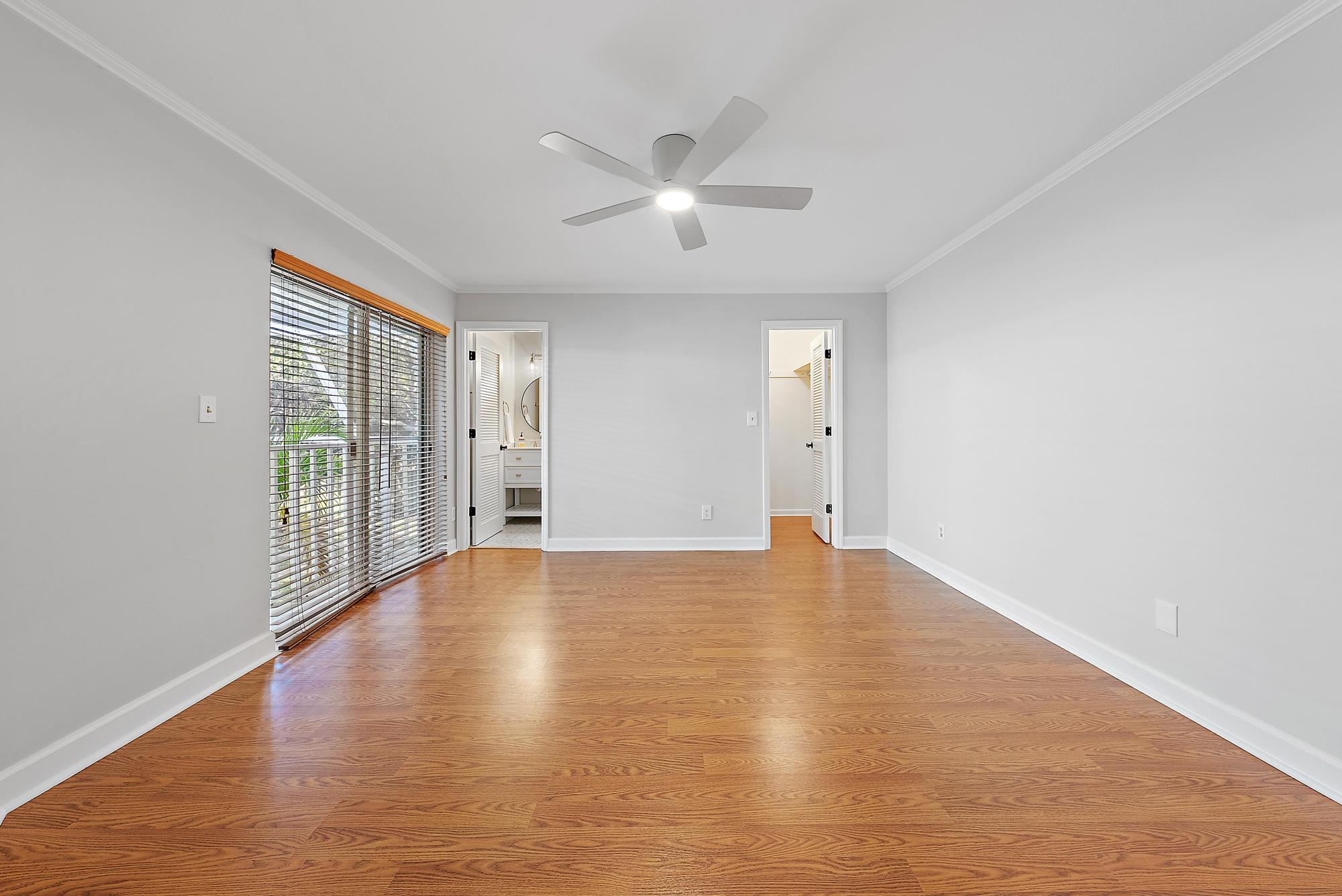 81 Southeast Beech Tree Lane Stuart, FL 34994 - Photo 20 of 27 an empty room with wooden floor and windows