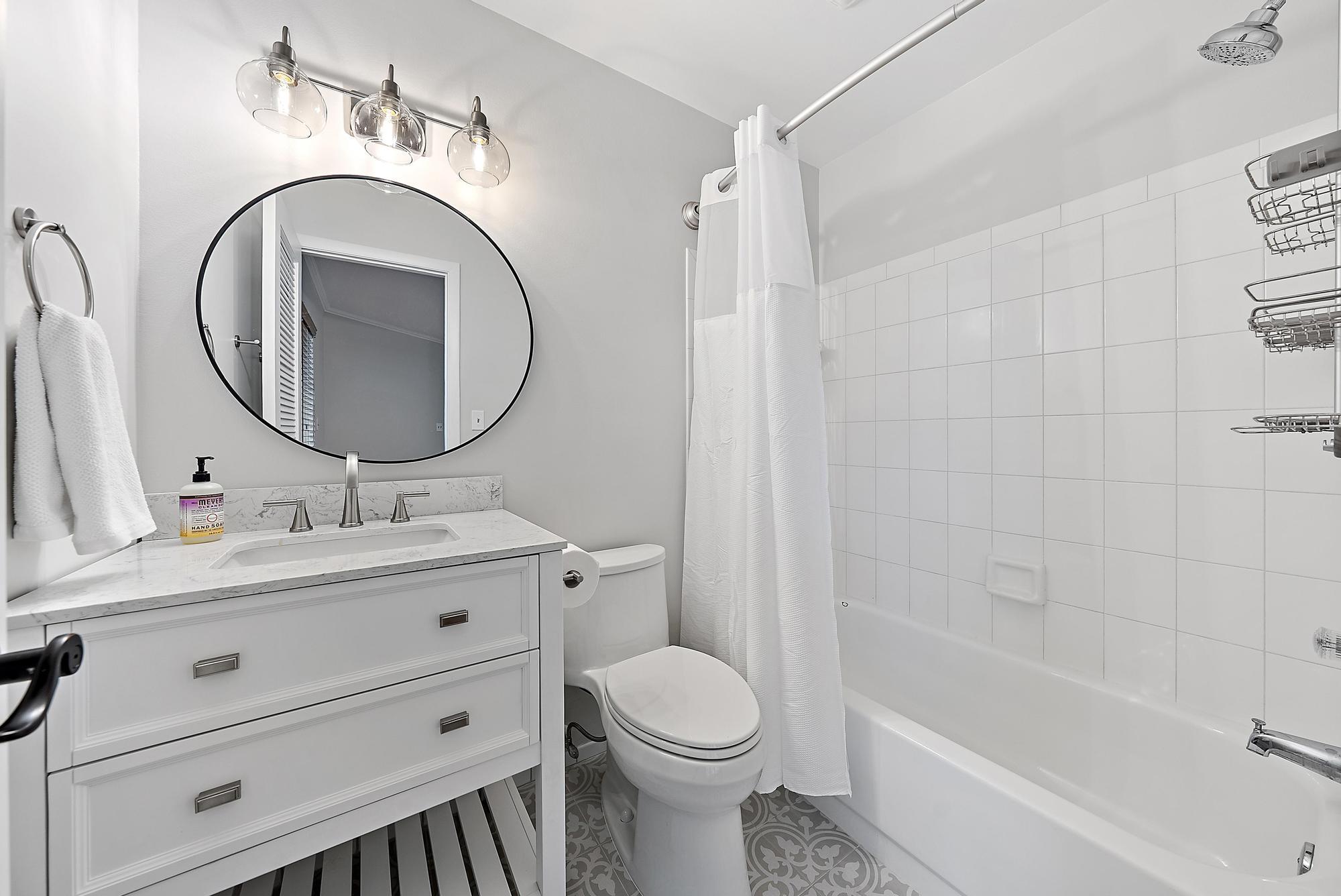 81 Southeast Beech Tree Lane Stuart, FL 34994 - Photo 21 of 27 a bathroom with a toilet sink and mirror