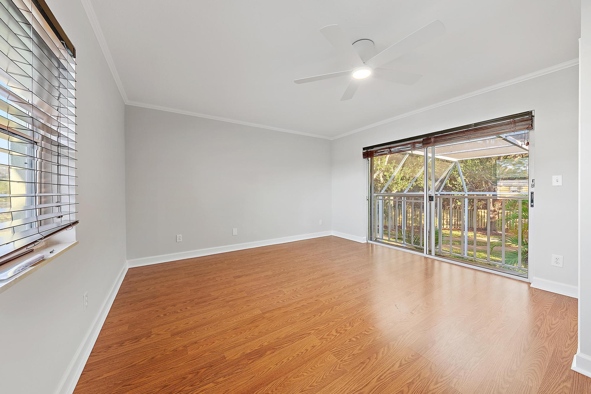 81 Southeast Beech Tree Lane Stuart, FL 34994 - Photo 22 of 27 a view of an empty room with wooden floor and a window