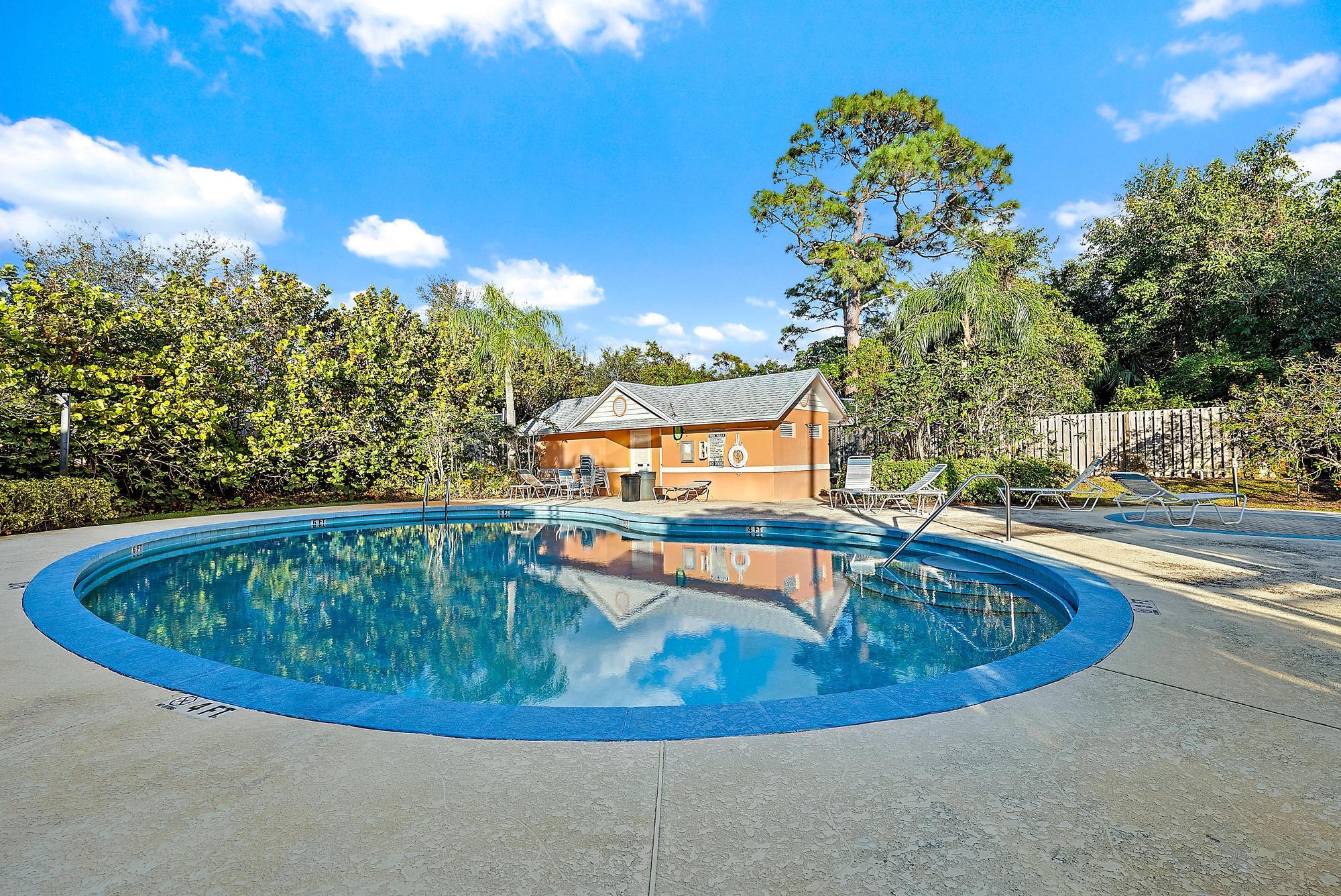 81 Southeast Beech Tree Lane Stuart, FL 34994 - Photo 25 of 27 a view of a swimming pool with a yard