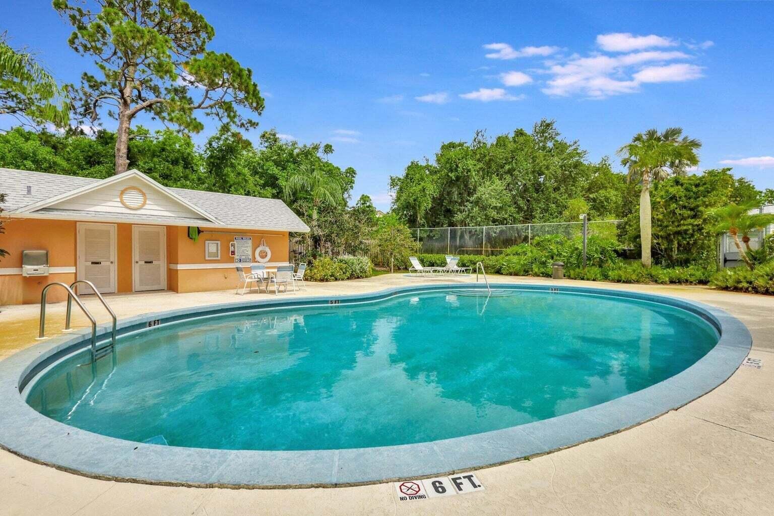 81 Southeast Beech Tree Lane Stuart, FL 34994 - Photo 26 of 27 a view of a swimming pool with a yard