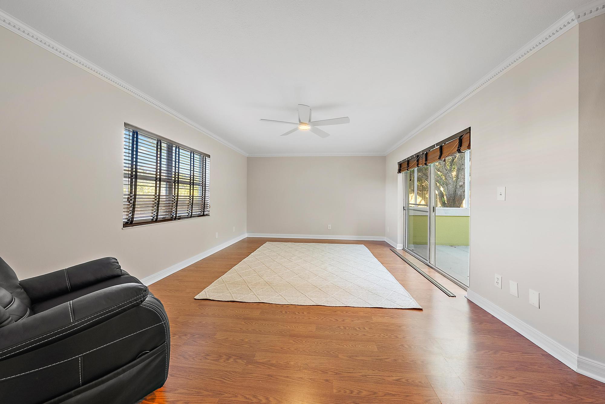 81 Southeast Beech Tree Lane Stuart, FL 34994 - Photo 9 of 27 a living room with a couch and a window