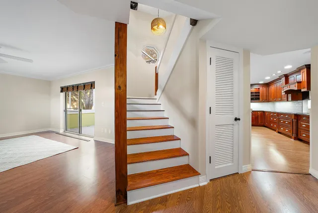 a view of a hallway view with wooden floor and staircase