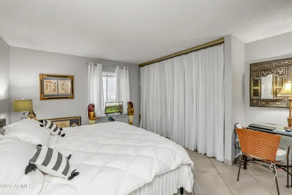 a bedroom with a bed and a dresser
