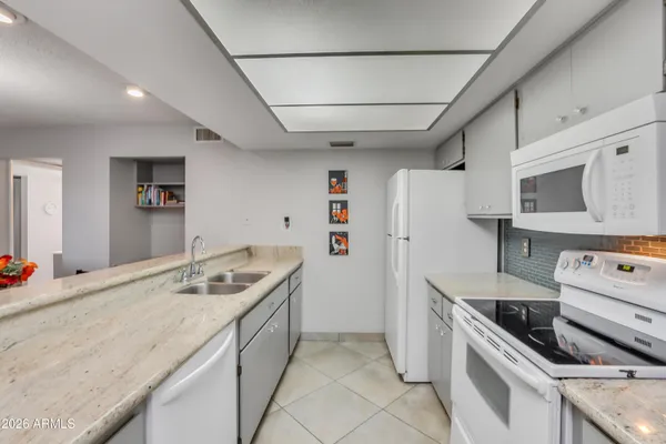 a kitchen that has a table and chairs in it