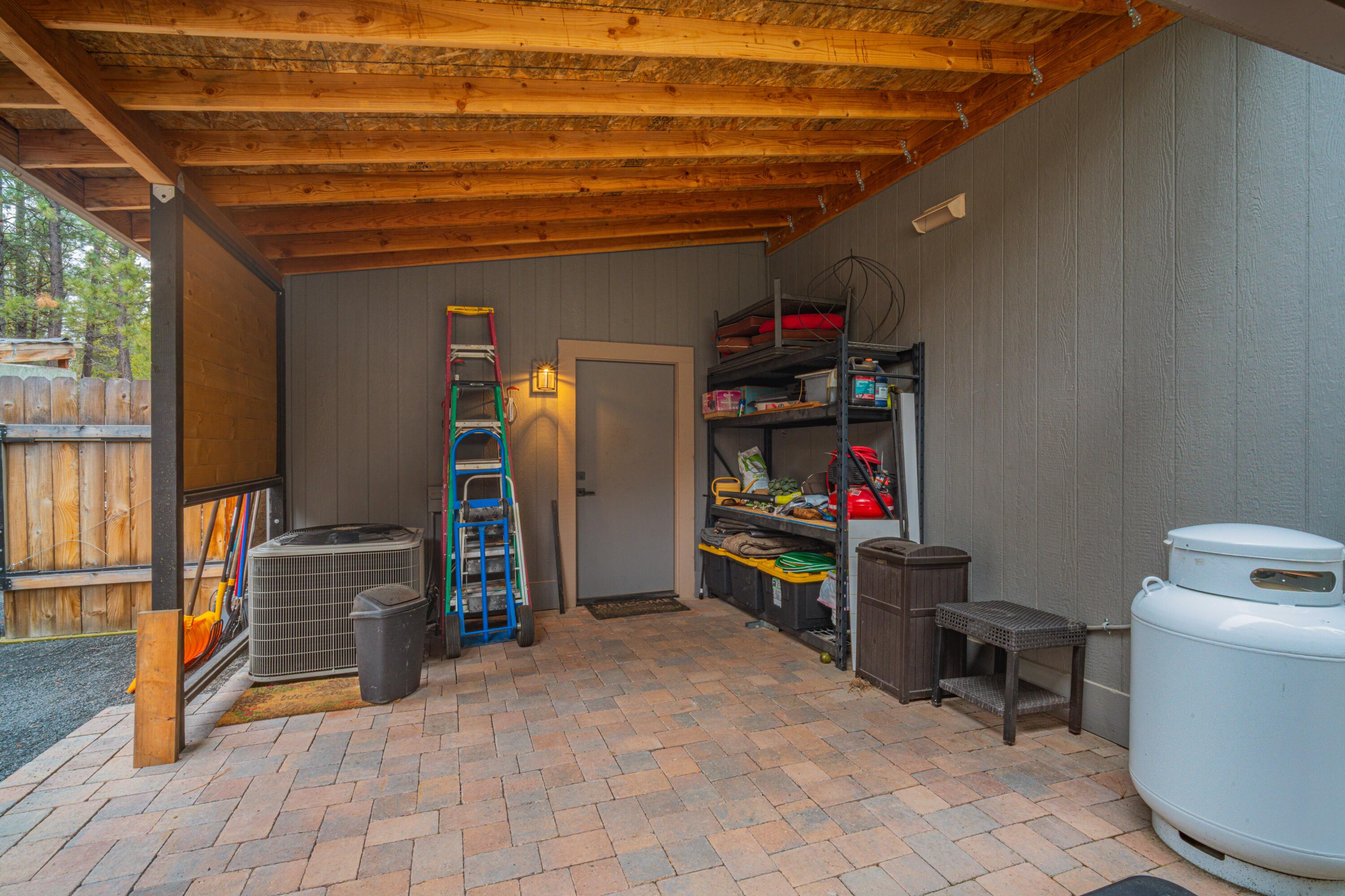 16927 Covina Road Bend, OR 97707 - Photo 35 of 54 Covered outdoor storage area adds practical utility to this extraordinary backyard setup, keeping everyday items organized and close at hand.