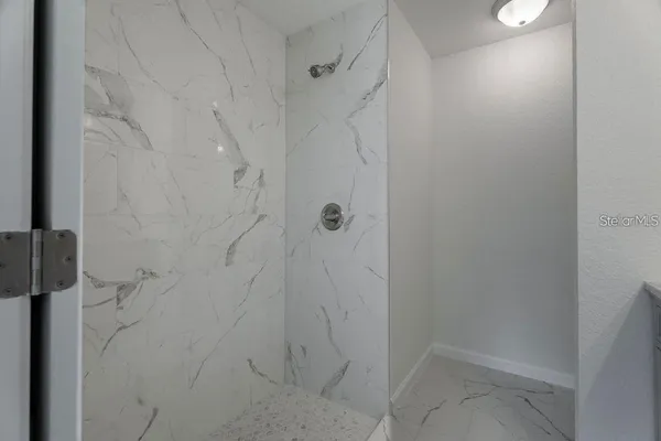 a bathroom with a granite countertop sink a mirror and a vanity