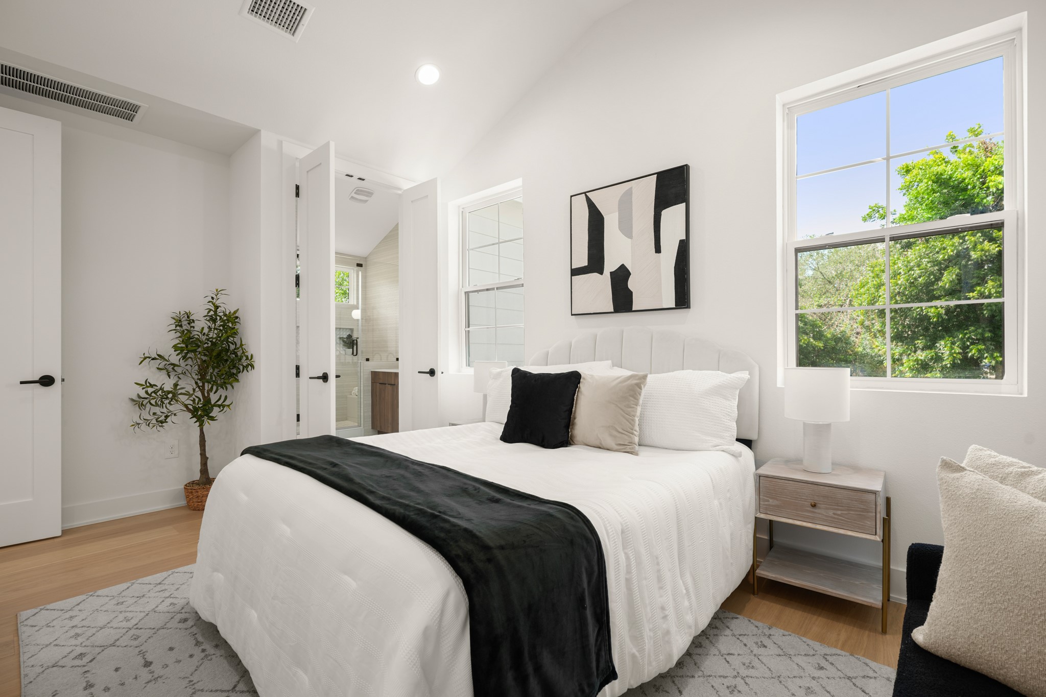 601 Vermont Road, Unit 2 Austin, TX 78702 - Photo 16 of 31 Vast windows illuminate this tranquil bedroom featuring vaulted ceilings and natural hardwood floors.