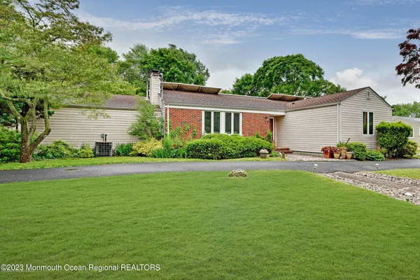a front view of house with yard and green space
