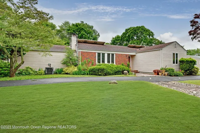 a front view of house with yard and green space