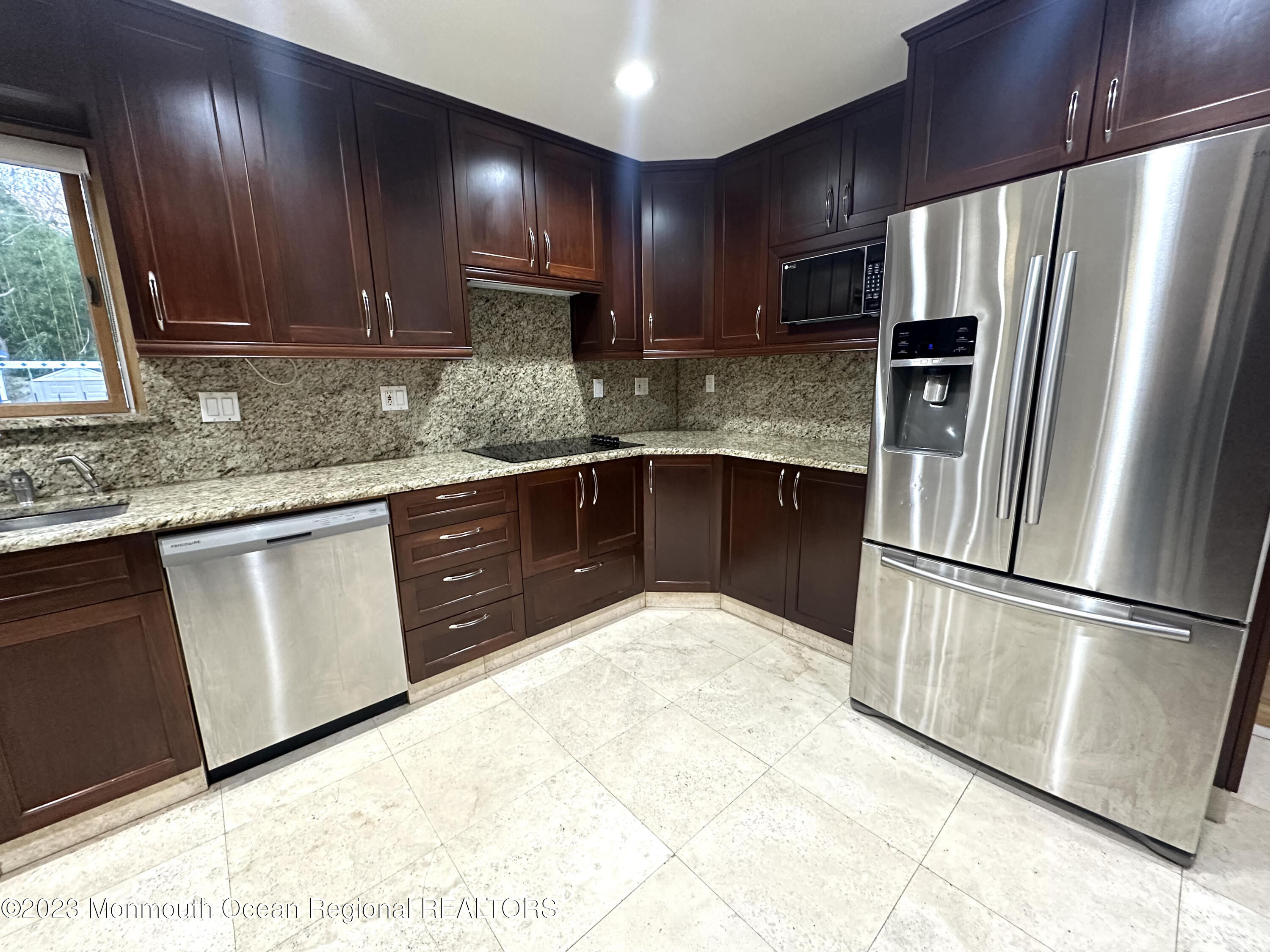 77 Pinewood Avenue West Long Branch, NJ 07764 - Photo 11 of 25 a kitchen with stainless steel appliances granite countertop a refrigerator sink and cabinets