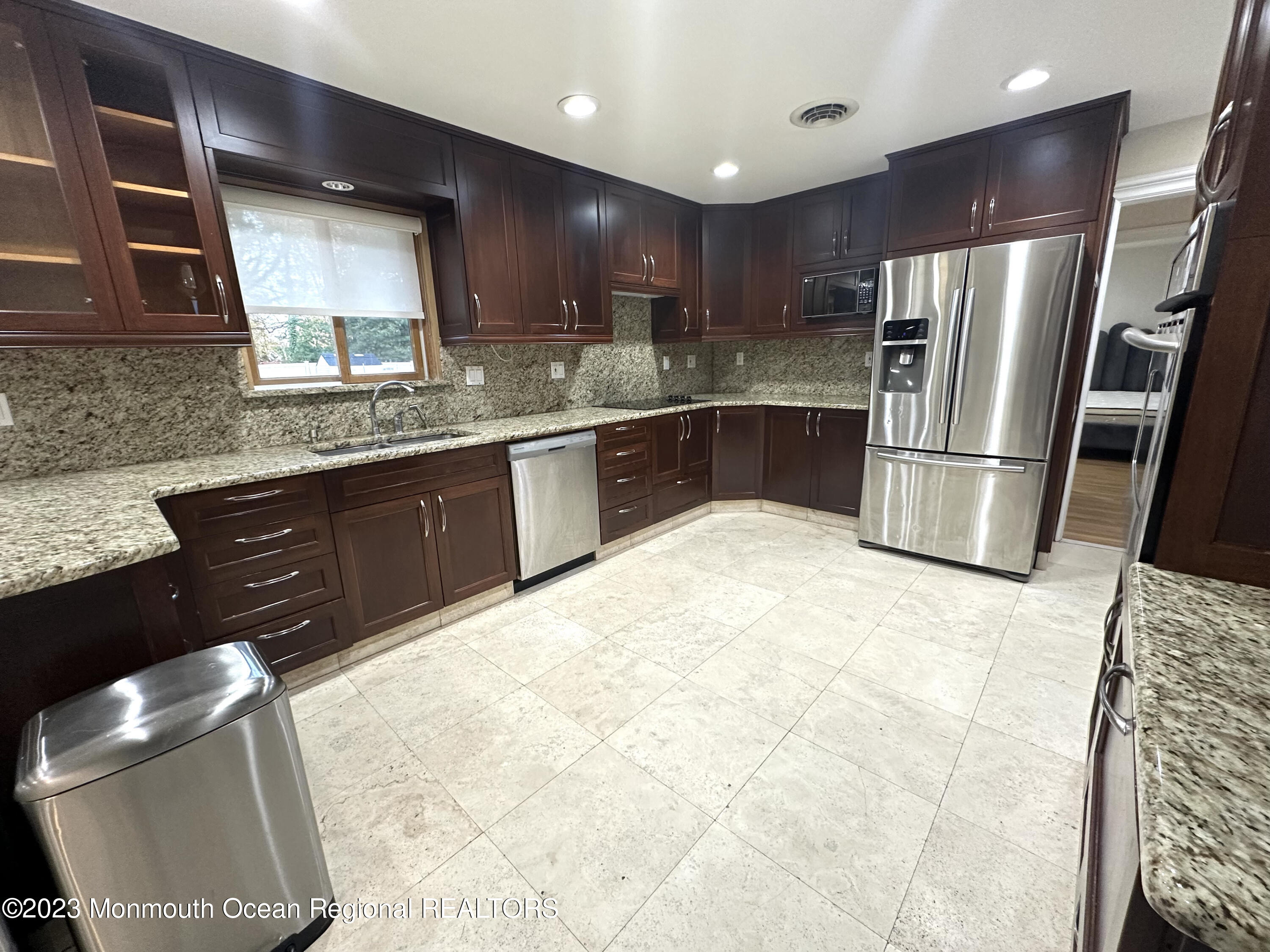 77 Pinewood Avenue West Long Branch, NJ 07764 - Photo 12 of 25 a kitchen with stainless steel appliances granite countertop a sink refrigerator and cabinets