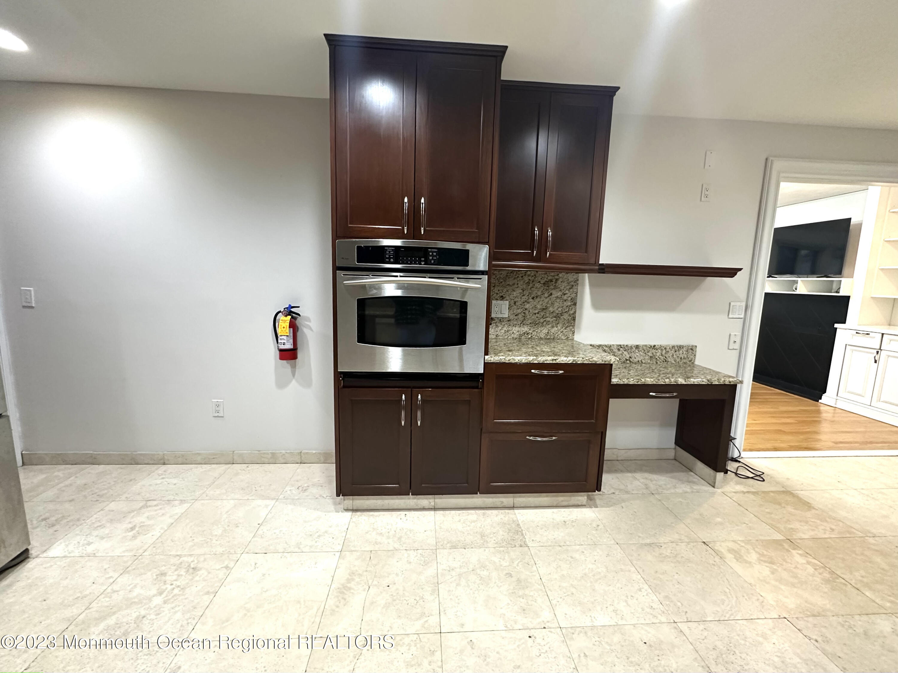 77 Pinewood Avenue West Long Branch, NJ 07764 - Photo 13 of 25 a kitchen with stainless steel appliances granite countertop a stove a sink and a refrigerator