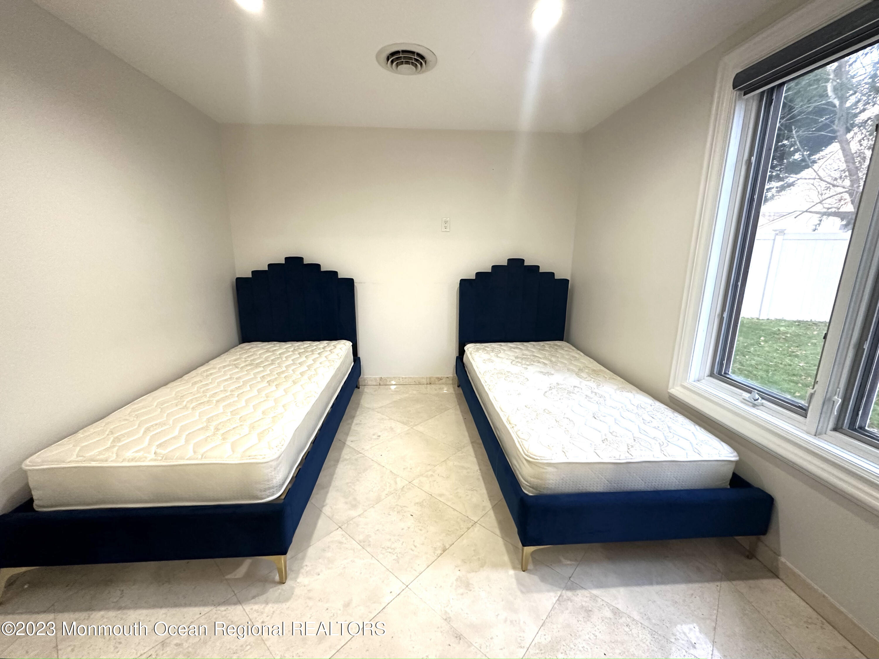 77 Pinewood Avenue West Long Branch, NJ 07764 - Photo 19 of 25 a bed sitting in a bedroom next to a window