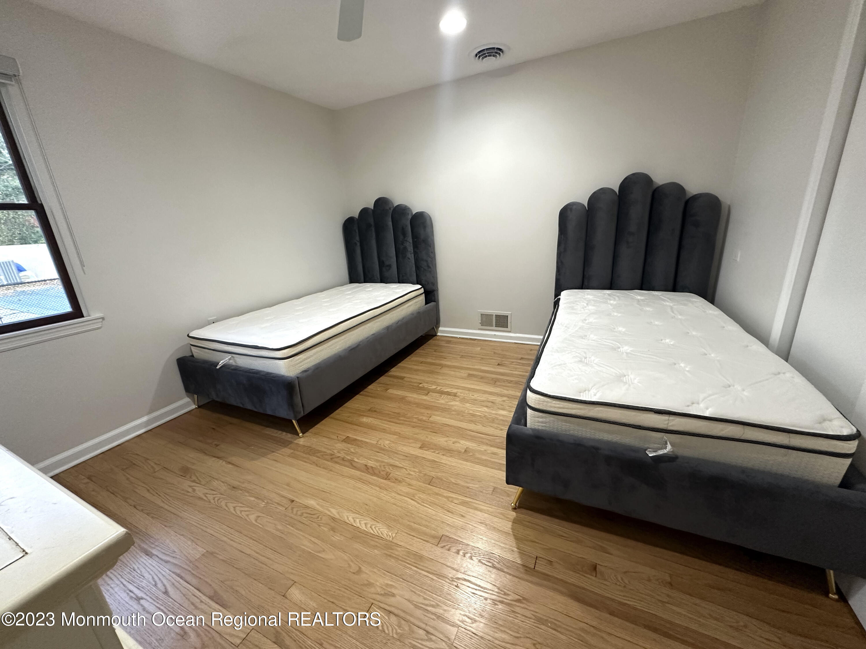 77 Pinewood Avenue West Long Branch, NJ 07764 - Photo 20 of 25 a living room with furniture and a wooden floor