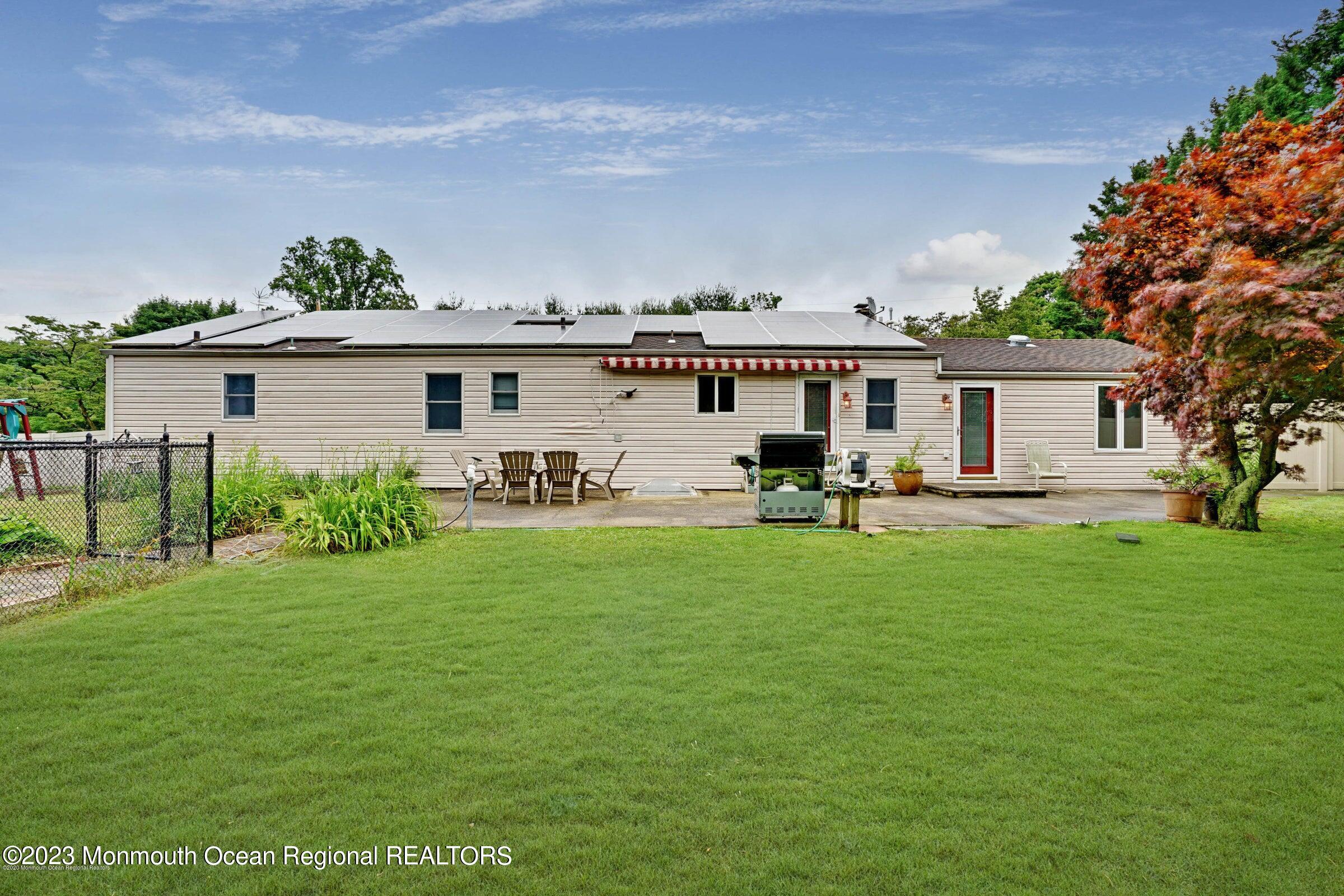 77 Pinewood Avenue West Long Branch, NJ 07764 - Photo 21 of 25 a front view of a house with a garden and yard
