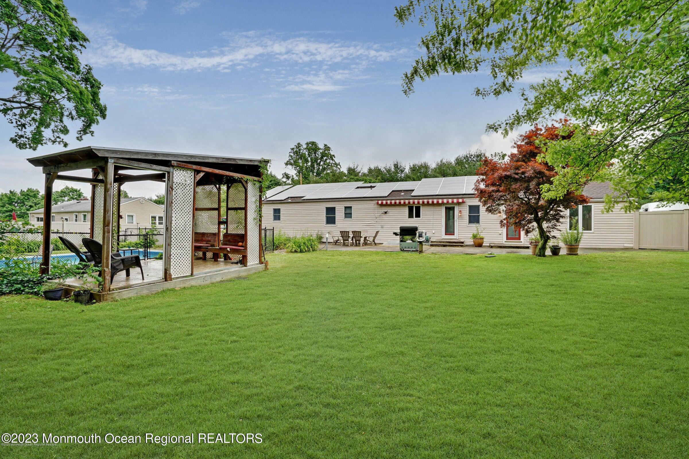 77 Pinewood Avenue West Long Branch, NJ 07764 - Photo 23 of 25 a front view of a house with a yard
