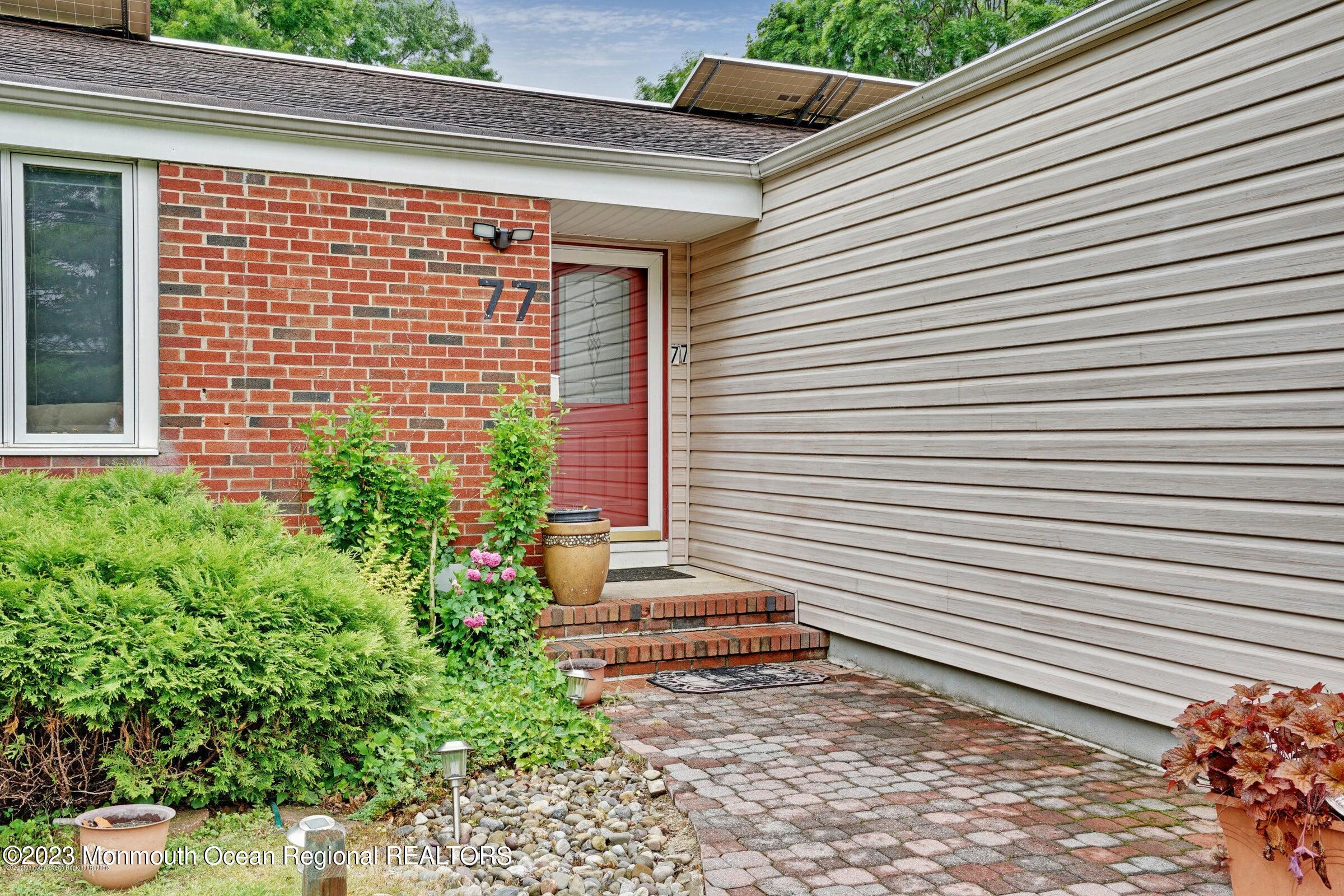 77 Pinewood Avenue West Long Branch, NJ 07764 - Photo 3 of 25 a view of a backyard with plants and the porch