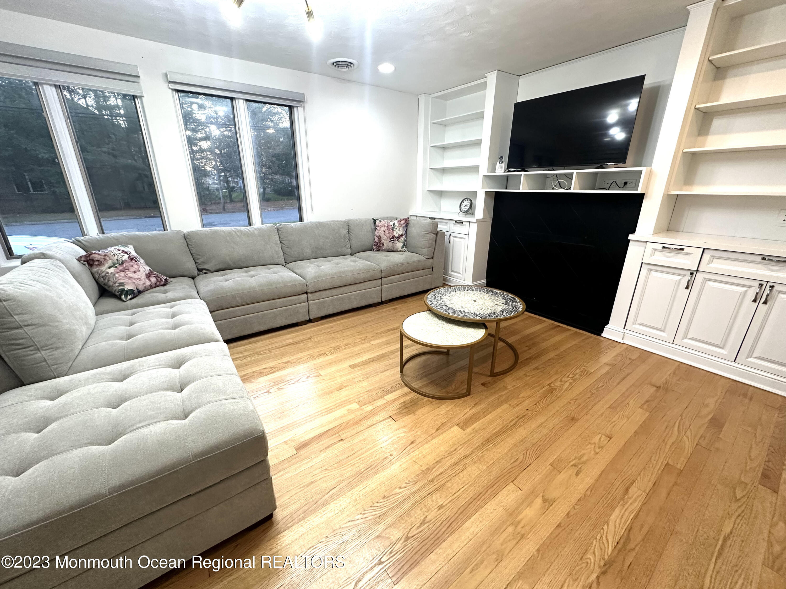 77 Pinewood Avenue West Long Branch, NJ 07764 - Photo 5 of 25 a living room with furniture and a flat screen tv