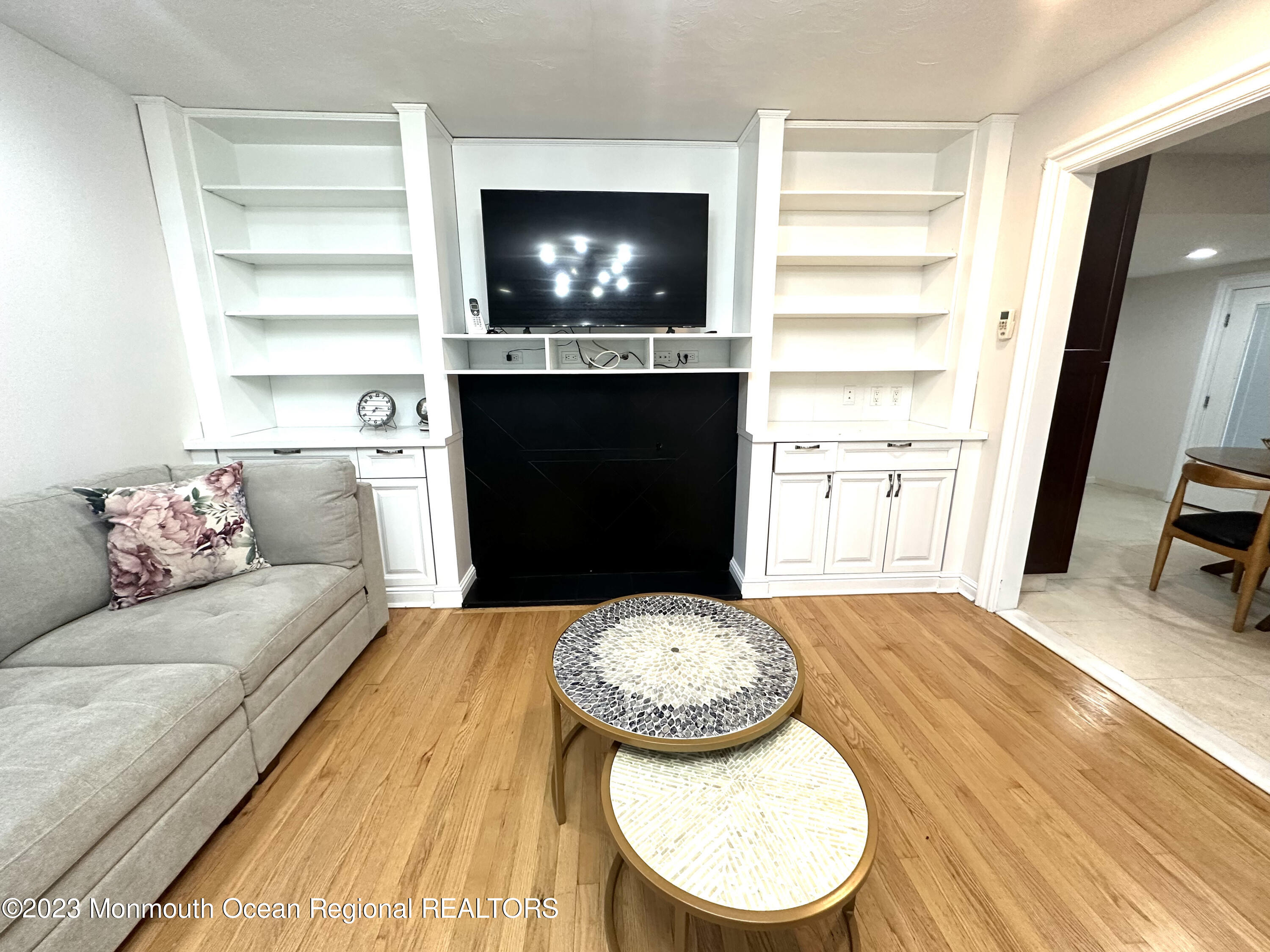 77 Pinewood Avenue West Long Branch, NJ 07764 - Photo 8 of 25 a living room with furniture and a fireplace