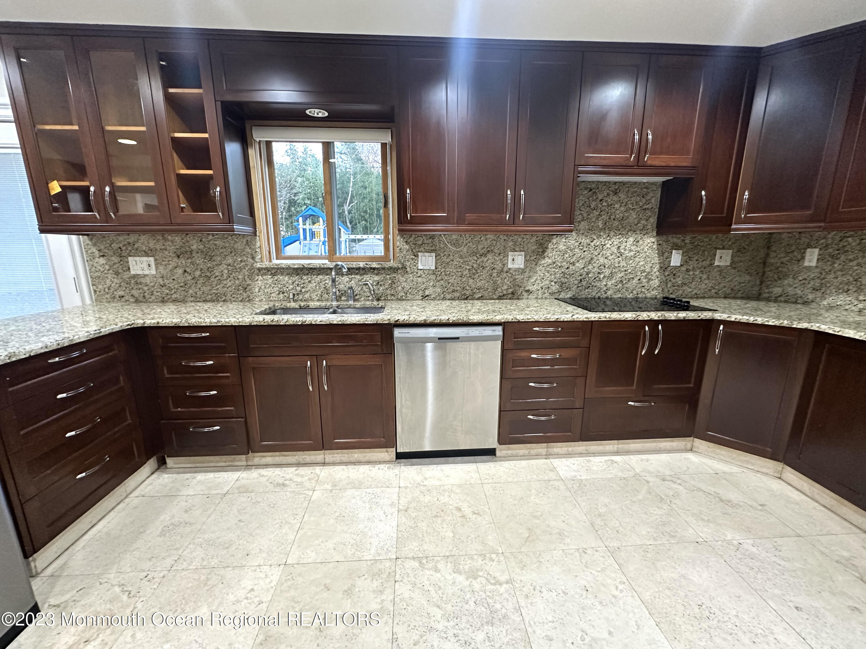 77 Pinewood Avenue West Long Branch, NJ 07764 - Photo 10 of 25 a kitchen with stainless steel appliances granite countertop a sink and cabinets
