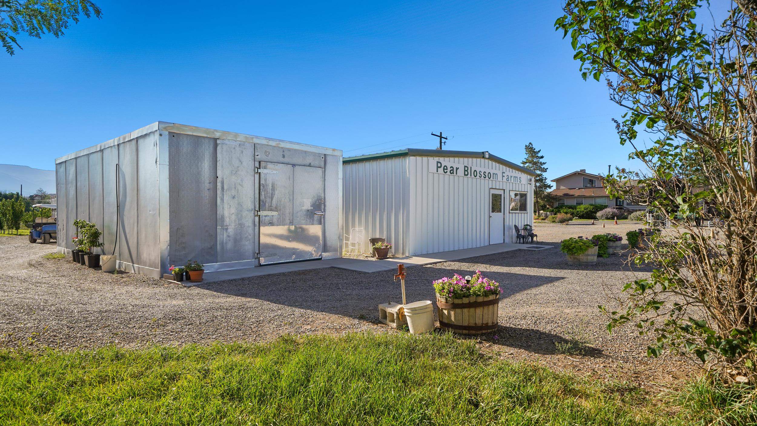 3376 C Road Palisade, CO 81526 - Photo 9 of 23 a backyard of a house with table and chairs