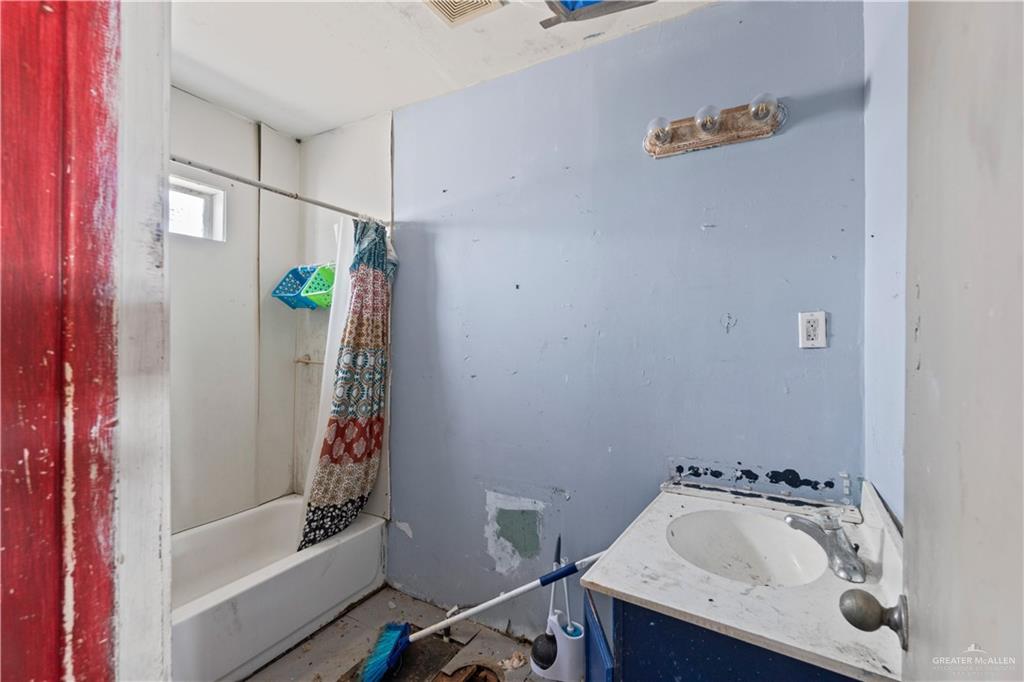 18301 Primera Road Harlingen, TX 78552 - Photo 10 of 15 a bathroom with a tub sink and mirror