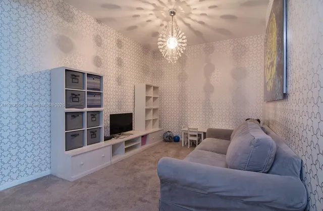 a living room with furniture windows and a flat screen tv