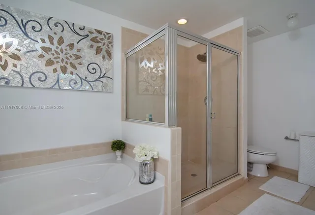 a bathroom with a bathtub and shower