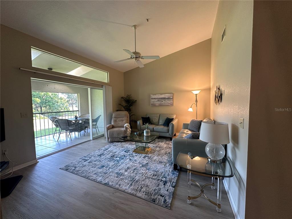 6713 Stone River Road, Unit 202 Bradenton, FL 34203 - Photo 3 of 31 a living room with furniture and a window