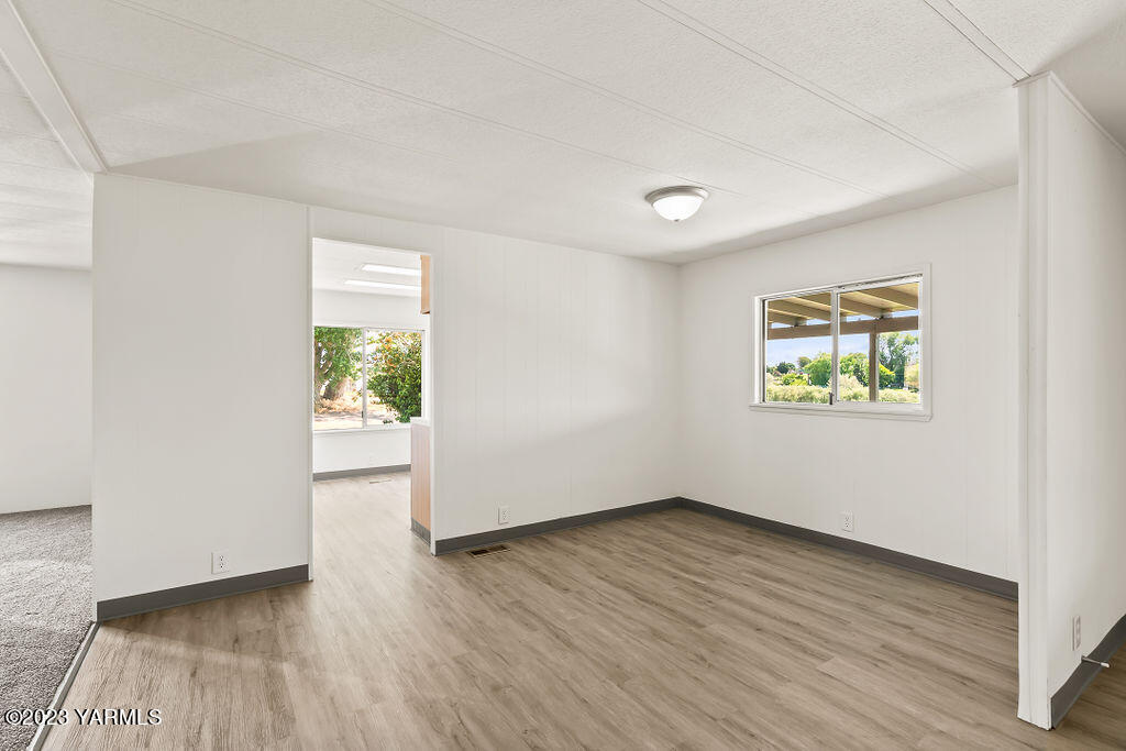 70 Albro Road Sunnyside, WA 98944 - Photo 6 of 33 an empty room with wooden floor and windows