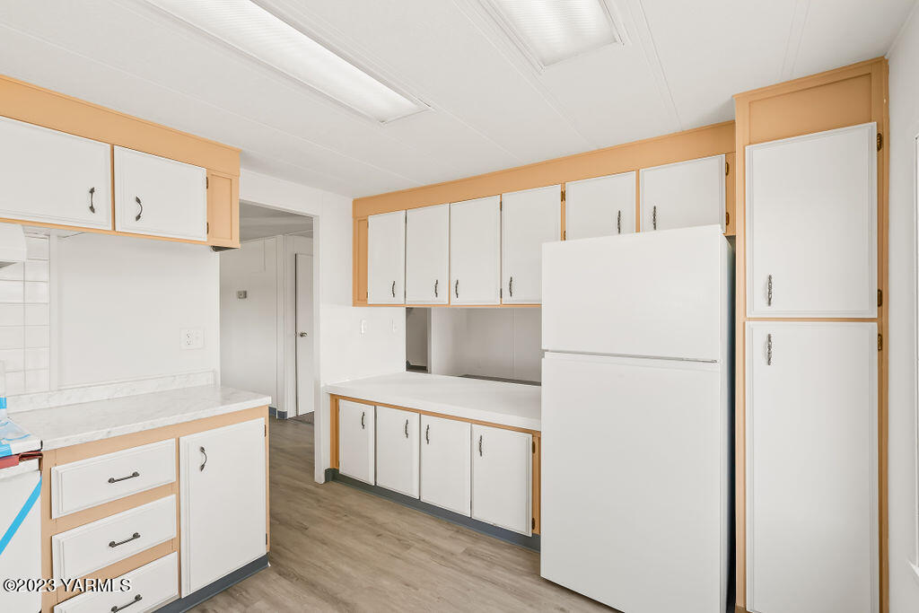 70 Albro Road Sunnyside, WA 98944 - Photo 8 of 33 a kitchen with cabinets appliances a sink and a large window