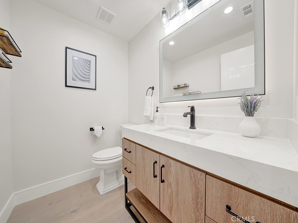 4652 Charnock Drive Irvine, CA 92604 - Photo 20 of 51 a bathroom with a toilet sink and mirror