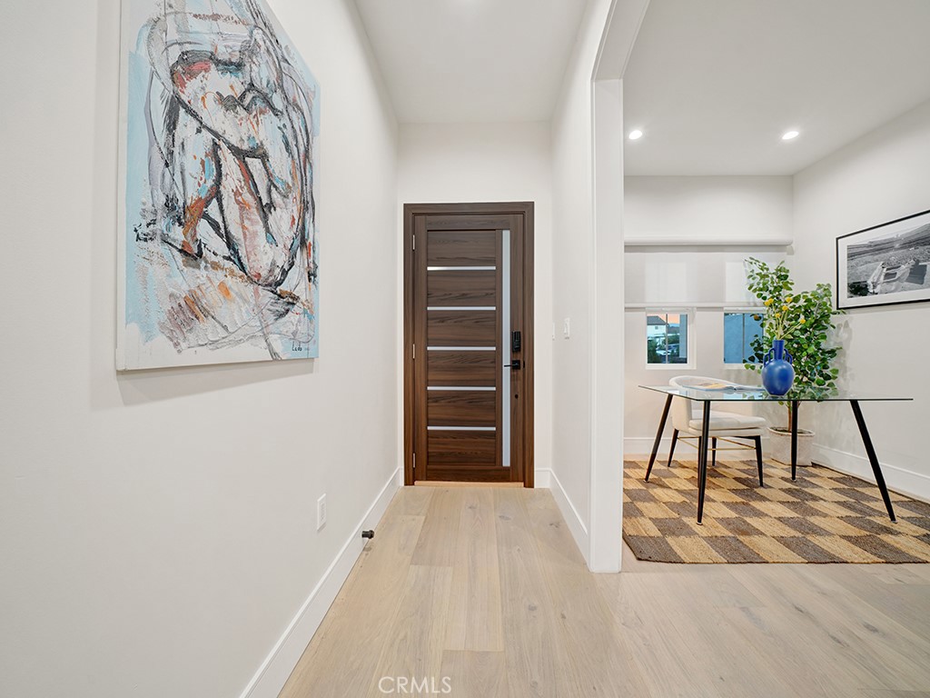 4652 Charnock Drive Irvine, CA 92604 - Photo 2 of 51 a view of a hallway with wooden floor and a workspace