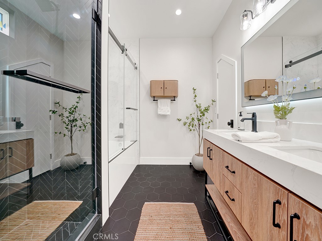4652 Charnock Drive Irvine, CA 92604 - Photo 24 of 51 a spacious bathroom with a double vanity sink a mirror and a shower