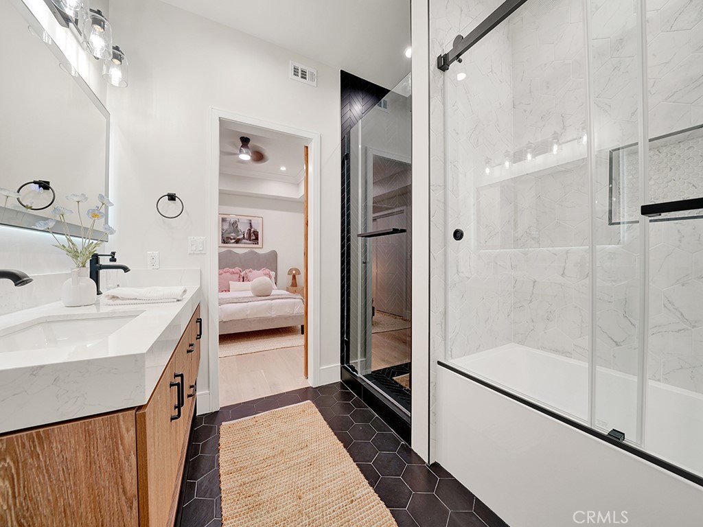 4652 Charnock Drive Irvine, CA 92604 - Photo 25 of 51 a en suite bathroom with a double vanity sink a mirror and shower