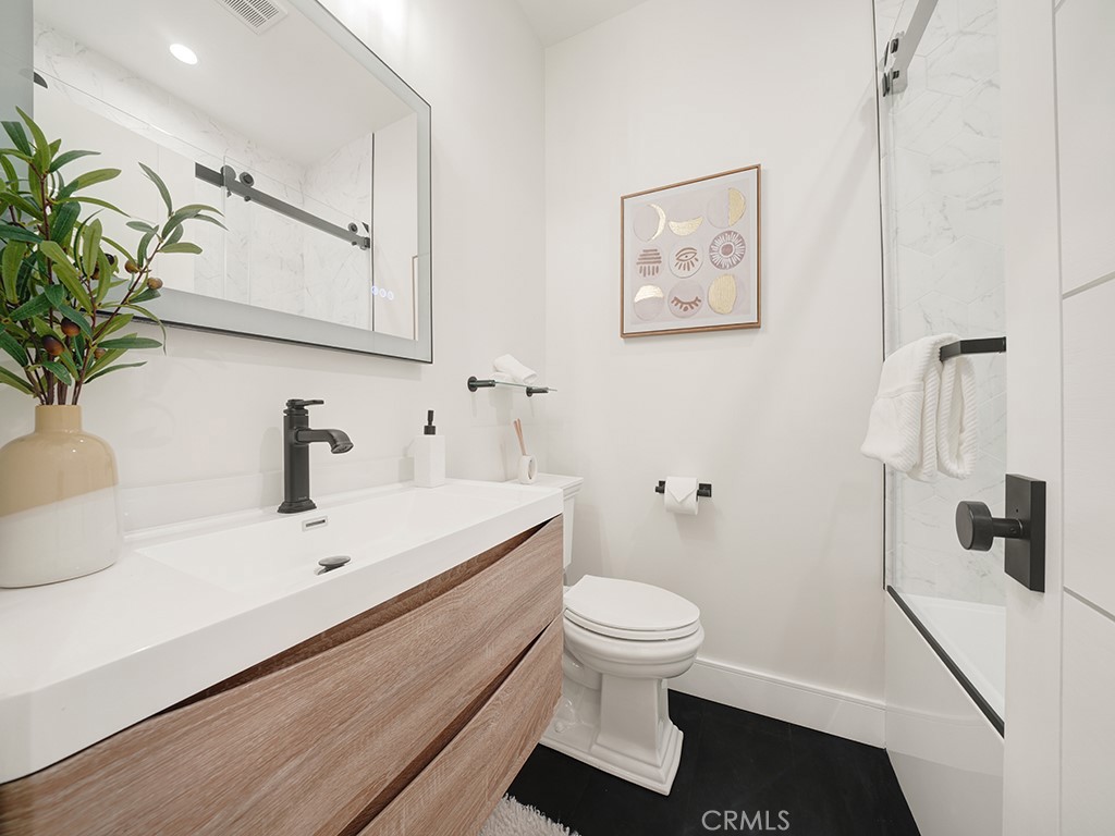 4652 Charnock Drive Irvine, CA 92604 - Photo 27 of 51 a bathroom with a sink and a mirror