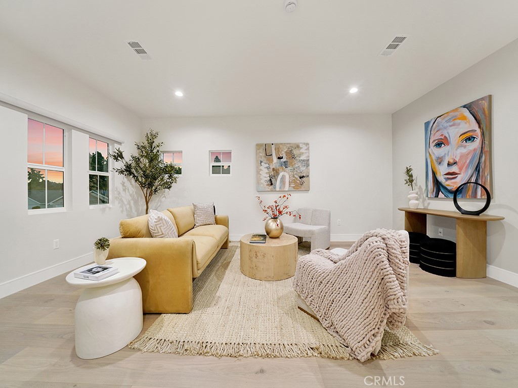 4652 Charnock Drive Irvine, CA 92604 - Photo 28 of 51 a living room with furniture and a flat screen tv
