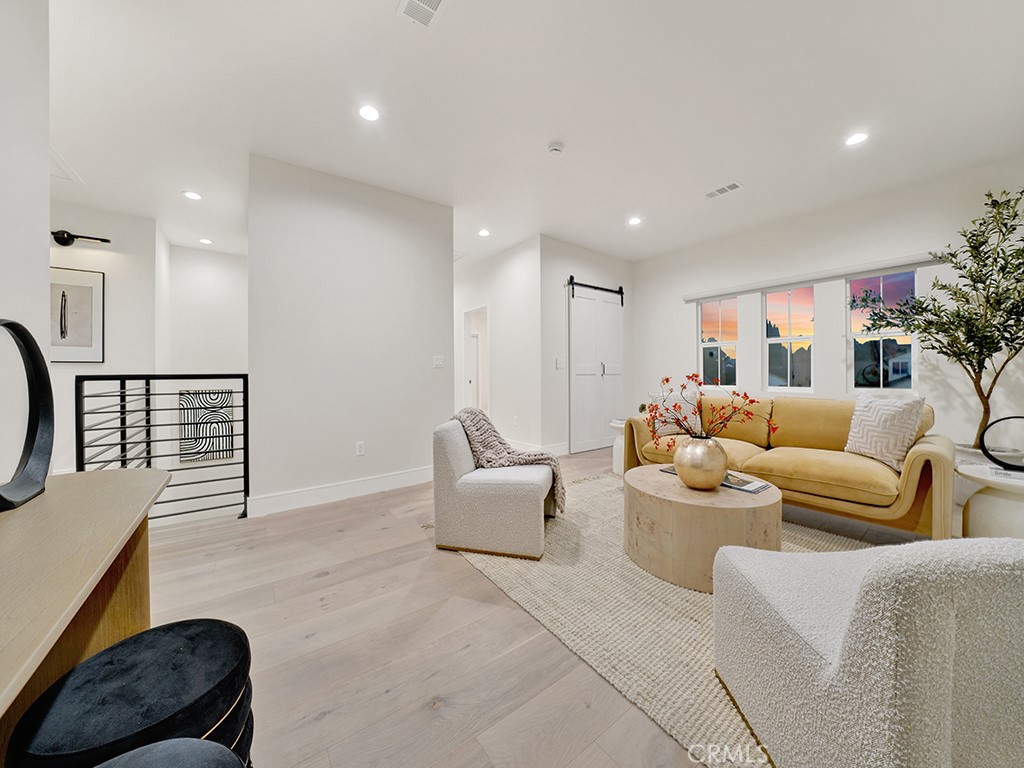 4652 Charnock Drive Irvine, CA 92604 - Photo 29 of 51 a living room with furniture a lamp and a potted plant