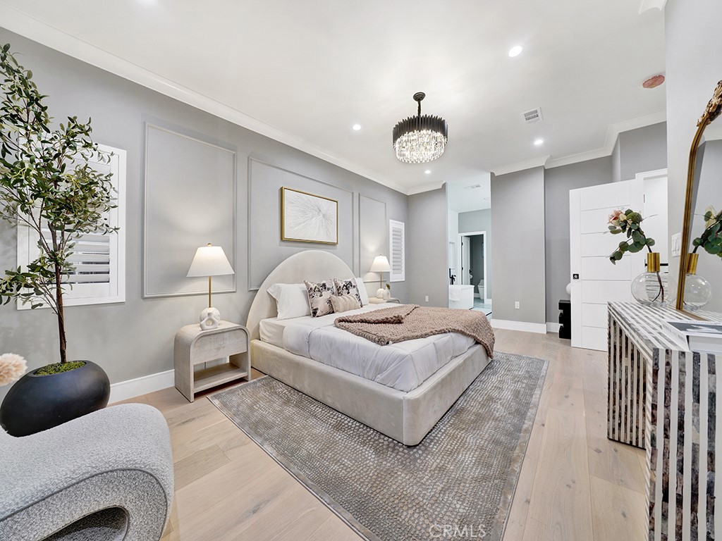 4652 Charnock Drive Irvine, CA 92604 - Photo 39 of 51 a bedroom with bed and a chandelier