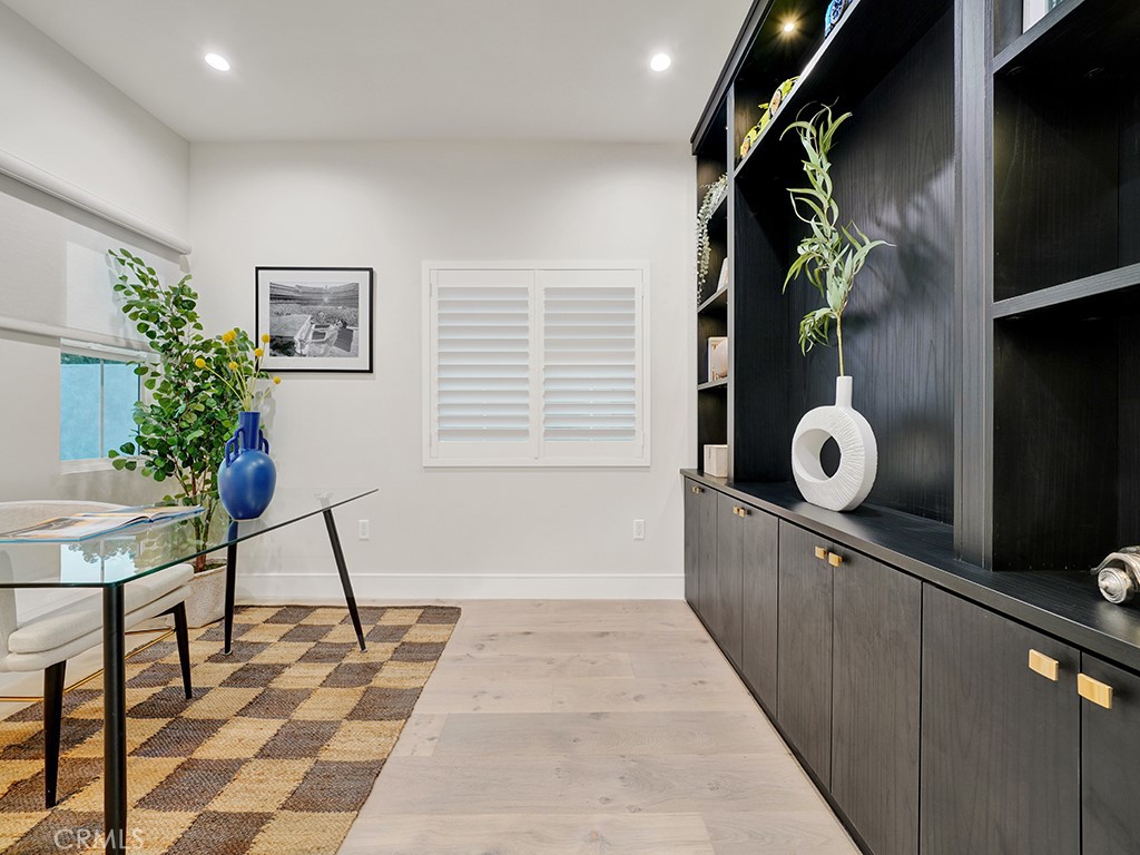 4652 Charnock Drive Irvine, CA 92604 - Photo 4 of 51 a living room with a potted plant and a rug