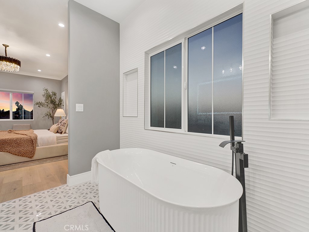 4652 Charnock Drive Irvine, CA 92604 - Photo 44 of 51 a bathroom with a tub and a mirror