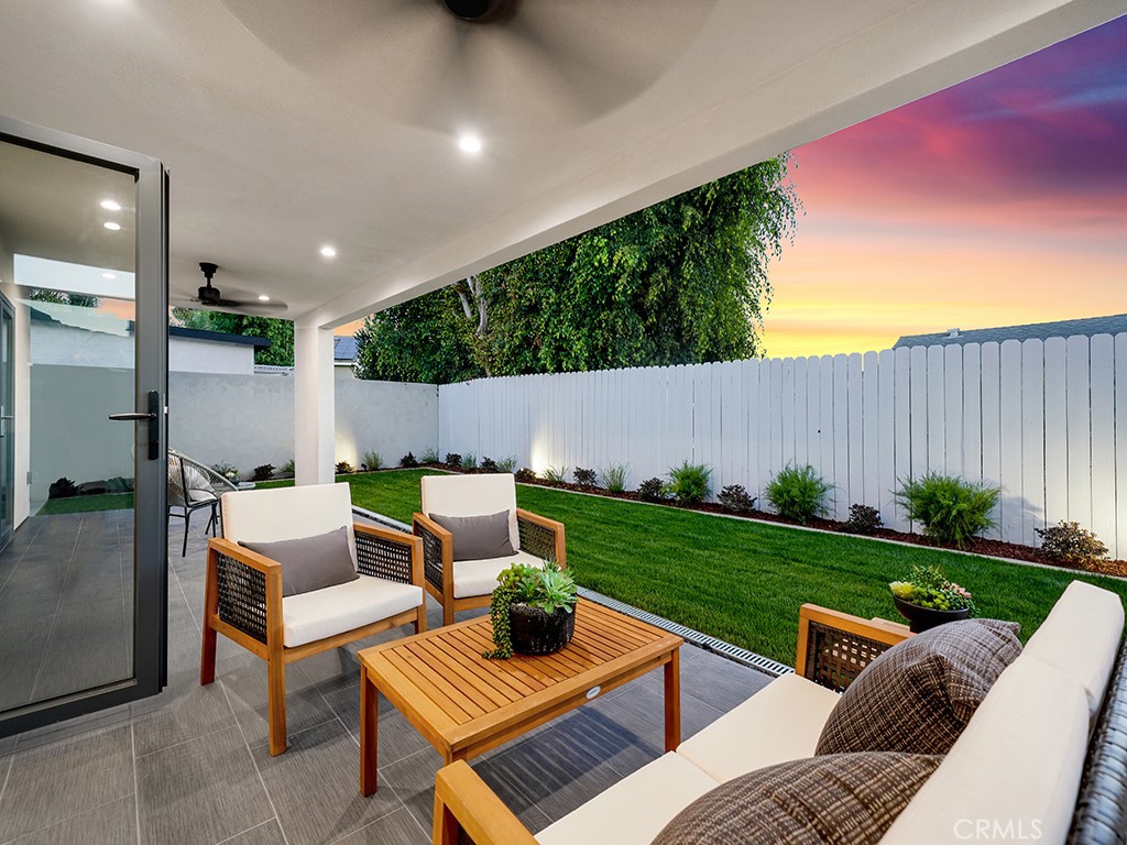 4652 Charnock Drive Irvine, CA 92604 - Photo 49 of 51 a view of a patio with couches and a table and chairs with plants and wooden fence